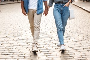 A couple hold hands as they walk down a brick road. This symbolizes the support couples therapy in Tampa, FL can provide. Learn more about couples counseling from a coupes therapist in Saint Petersburg, FL. 33609 | 33703 |33704