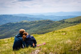 A couple sit together as they look out over the mountain range before them. Couples therapy in Tampa, FL can help cultivate stronger bonds. Contact a marriage counselor in Tampa, FL for support with marriage counseling and other services. 33609 | 33704 | 337703
