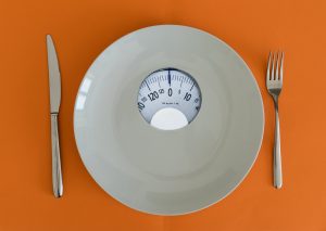 A close up of a plate with a scale in the middle. This could repreesent the struggles of eating disorders an online eating disorder therapist in Tampa, FL can offer support with overcoming. Learn more about online eating disorder therapy in Tampa, FL today.