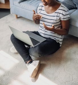A person sits on the floor while talking to their laptop. Learn how online eating disorder therapy in Tampa, FL can support body image from the comfort of home. Learn more by contacting an eating disorder therapist in Tampa, FL, or searching for eating disorder treatment in ST. Pete, FL today. 
