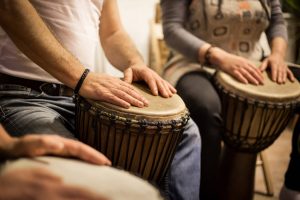 A close up of people sitting in a drum circle. This could represent the benefits of music therapy and working with a therapist in St. Pete, FL. Contact a psychologist in St. Pete, FL for support with EMDR trauma therapy in St. Petersburg, FL.